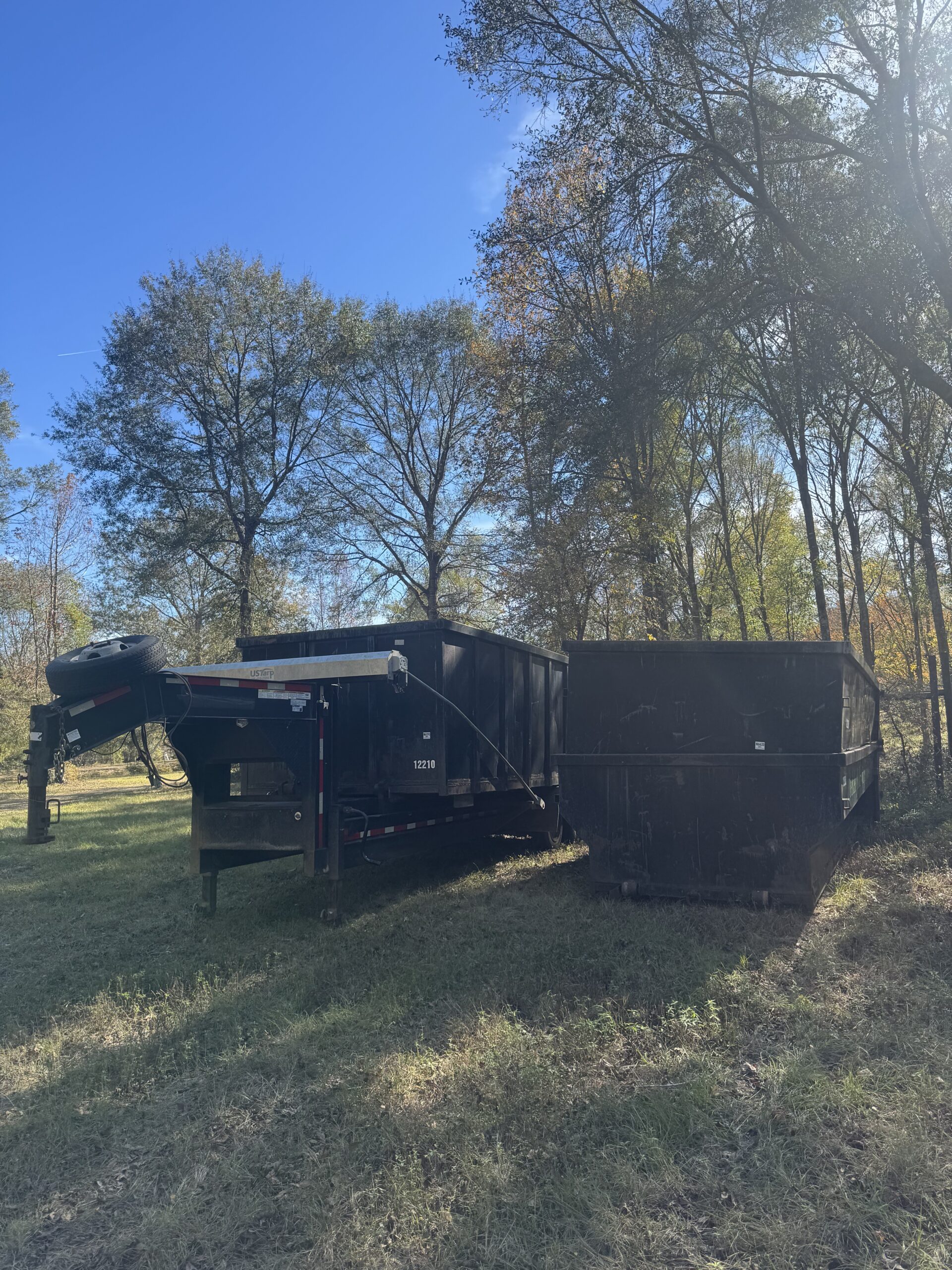 WillWay Dump and Junk truck hauling a dumpster through Collin County Texas